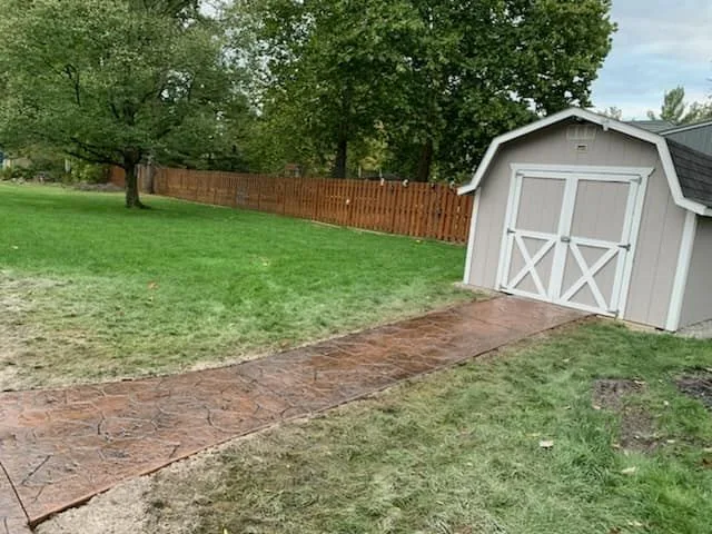 Stamped walkway to backyard shed